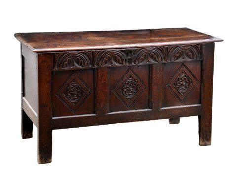 A late 17th century carved oak three panel coffer, the thumb moulded lid on original split pin hinges, over a foliate arcaded