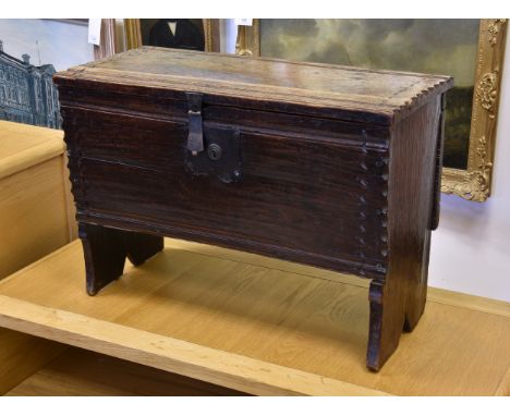 A late 17th / early 18th century miniature oak six plank coffer, the chip and channel carved top with penwork geometric decor
