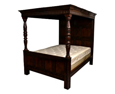 A Charles II style oak full tester four poster bed, first half 20th century, the full, panelled canopy within a dentil and ar