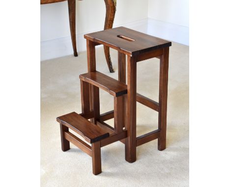 A set of metamorphic mahogany and beechwood library steps, converting from a stool into a set of three steps, with pierced ha