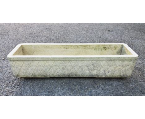 A composite stone planter by Grandon Fres France, 27¼ x 7¾in. (69.2 x 19.6cm.), 6in. (15.2cm.) high. 