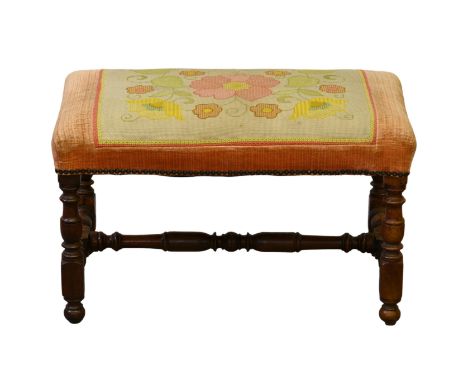 A 19th century turned walnut stool, in the late 17th century style, with floral petit point and pink velvet seat, raised on t