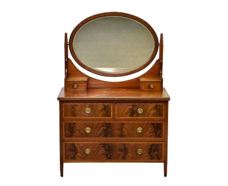 An Edwardian mahogany and satinwood banded dressing table, the oval mirror over two small drawers and a satinwood banded top,