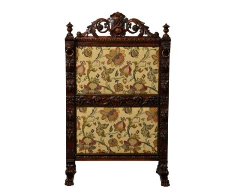 A Victorian carved oak Carolean revival fire screen, the two panel frame carved with foliage, egg &amp; dart border and grote