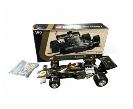 1973 Corgi 1/18th scale JPS Lotus F1 racing car with unused helmet labels (Fittipaldi &amp; Peterson) and take-off wheels too
