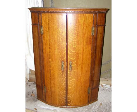 A Georgian oak bow front corner cupboard, Height 38&rdquo;, Width 28&rdquo;