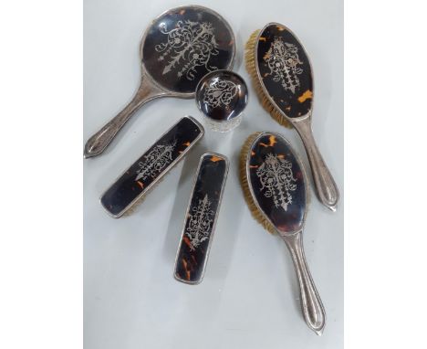 Circa 1910, a silver and tortoiseshell picquot 6 piece dressing table set comprising 4 brushes, a hand mirror and a glass pot