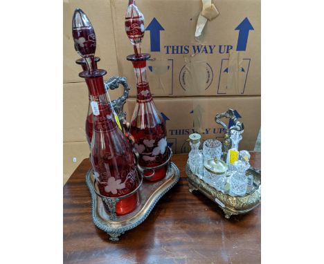 Victorian Sheffield plated on copper three-bottle decanter stand, with three Bohemian ruby flashed and wheel engraved wine bo