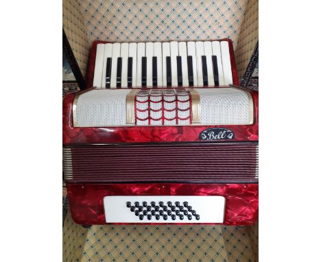 A Bell bass piano accordion with 32 keys in a faux crocodile case made by the Weltmeister factory in Germany, with shoulder s