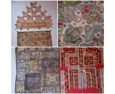 A 20th Century Indian gold coloured silk cushion panel A/F having hand sewn needlepoint images of paisley and Eastern pattern