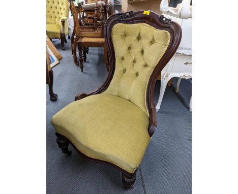 A Victorian mahogany nursing chair having button back upholstery, serpentine front and front bulbous legsLocation: 