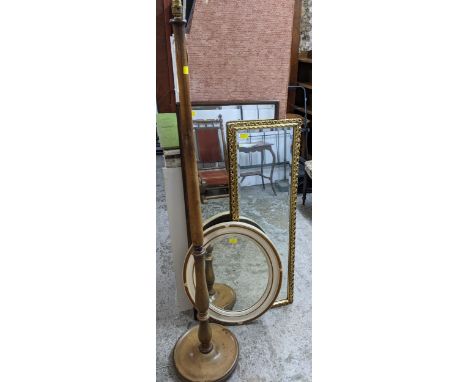 An early 20th century mahogany standard lamp, and three wall mirrors to include a white painted and gilt wood oval framed mir