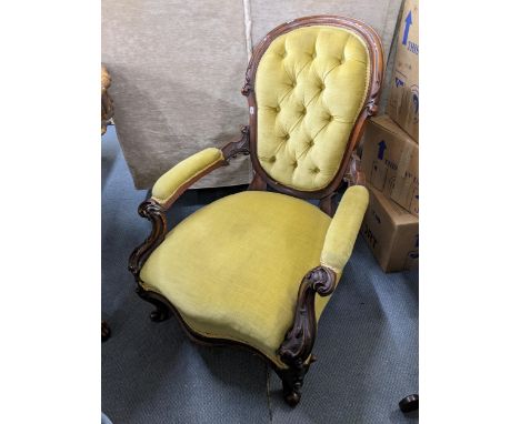 A Victorian mahogany salon armchair having button back upholstery and a carved scroll frameLocation: 