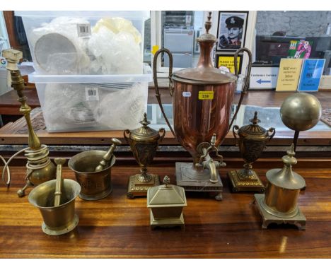 A quantity of Victorian or earlier brass and copper ware to include a tea urn, gilt metal mantle urns, pestle and mortars, we