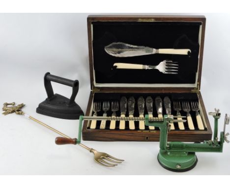 A patent apple peeler and corer, with a green finish; together with toasting fork, flat iron and a boxed set of fish eaters.