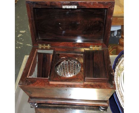 A Victorian rosewood sarcophagus tea caddy, with twin lidded interior on flat bun feet, W. 32cm.
