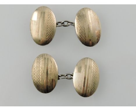 A pair of silver gilt cuff links, with oval engine turned tabs.