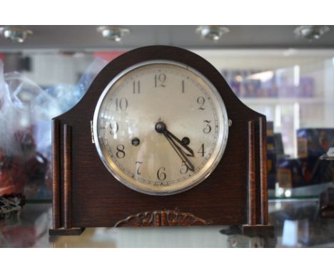 An Art Deco style oak-cased mantel clock.