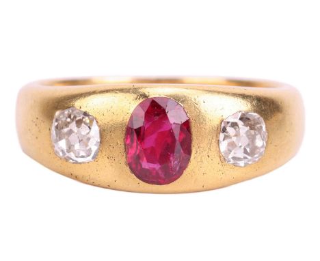 A ruby and diamond three-stone gypsy ring, centred with an oval-cut ruby in deep pinkish-red colour, approximately measuring 