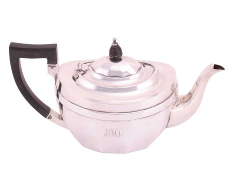 A silver teapot, panelled oval form, with ebonised handle and finial. Monogram engraved to centre. Chester 1924 by Barker Bro