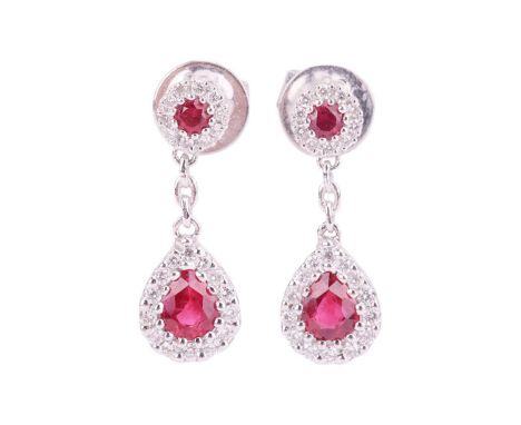 A pair of ruby and diamond cluster drop earrings, featuring pear-shaped rubies surrounded by round brilliant diamonds suspend