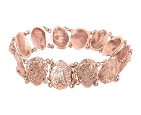 A textured mollusc link bracelet; comprising fourteen links with chain link connections and a concealed push-button clasp wit