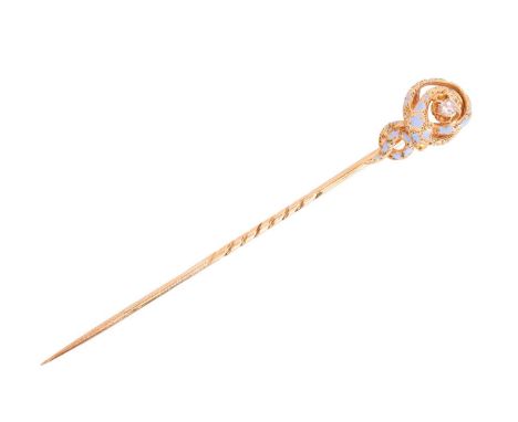 A diamond-set enamel serpent stick pin, featuring a coiled snake wrapping around an old-cut diamond in claw setting, textured