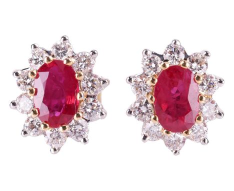 A pair of ruby and diamond cluster earrings, the central oval-cut rubies measuring approximately 6.0 x 4.0 mm, and surrounded