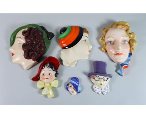 A Czechoslovakian Pottery Female Head Pattern Wall Plaque and Ten Others, the head with wavy blonde hair and blue stripe scar