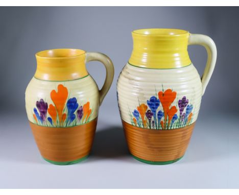 Crocus, a Clarice Cliff Bizarre Single-Handled Lotus Jug and a Single-Handled Isis Jug, each painted in colours between yello