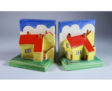A Pair of Clarice Cliff Bizarre Cottage Bookends, shape 410 modelled with yellow cottages with red roofs, 5.5ins high, printe