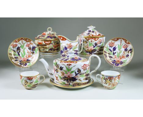 A Coalport Porcelain Part Tea Service, Circa 1810, painted and gilded with an Imari design, comprising - oval teapot, cover a