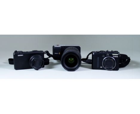 A Selection of Digital Cameras and Accessories, comprising - a Canon Powershot G9 digital camera, boxed with charger, a Sigma