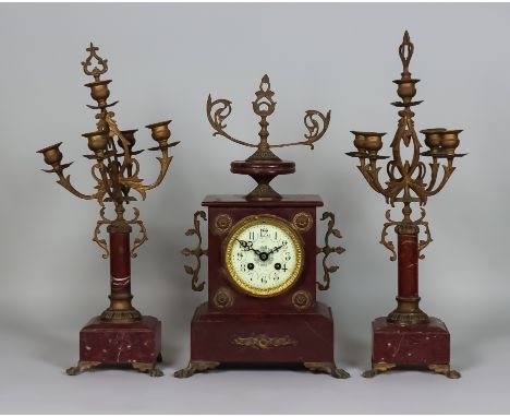 A Late 19th Century French Rouge Marble Clock Garniture, the clock with 3.5ins dial with Arabic numerals, to the eight day mo