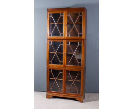 An Edwardian Mahogany Three-Tier Cabinet, by Morris &amp; Co. Art-Workers Ltd., each tier fitted one shelf enclosed by a pair