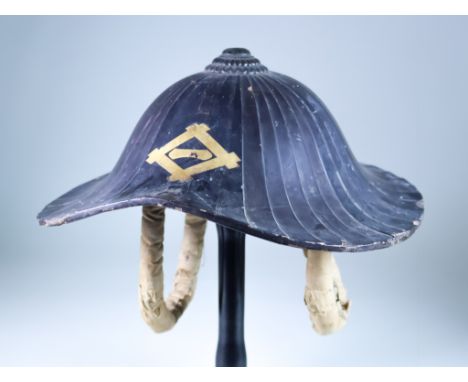 A Japanese Jingasa Helmet, Late19th/Early 20th Century, of fluted lacquer construction, linen chin straps, underside bearing 
