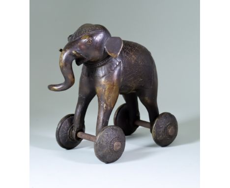 An Indian Bronze Temple Toy Elephant, on wheels 8ins (20.3cm) high