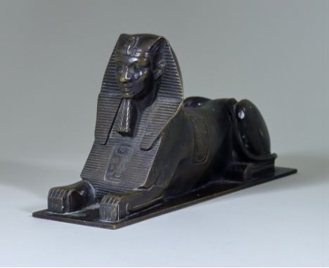 A Brown Patinated Bronze Model of a Sphinx, on rectangular base 11ins overall x 5.75ins high