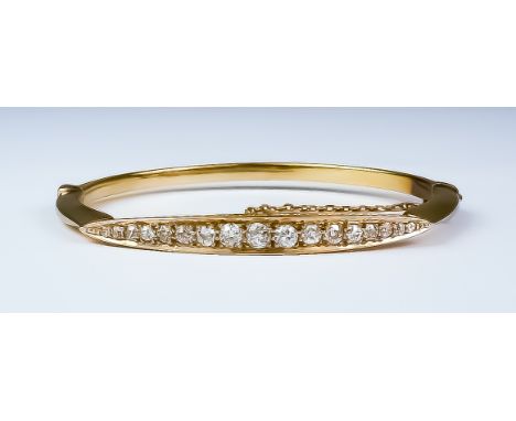 A Diamond Stiff Bangle, 20th Century, yellow metal set with seventeen small brilliant cut diamonds, approximately 1.5ct total