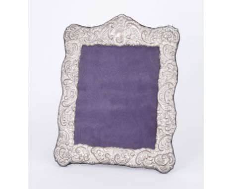 An Elizabeth II Silver Rectangular Photograph Frame, by Carrs of Sheffield 1989, of shaped outline embossed with sea scroll f