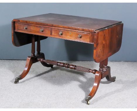 A William IV Rosewood Sofa Table, with cross banded edge to top, fitted two real and two dummy frieze drawers on twin reeded 