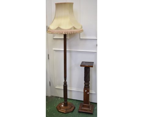 An early 20th century mahogany carved pedestal; an oak floor standing lamp (2)