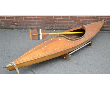A hardwood canoe, 362cm long, labelled in gilt lettering 'Ondinette'