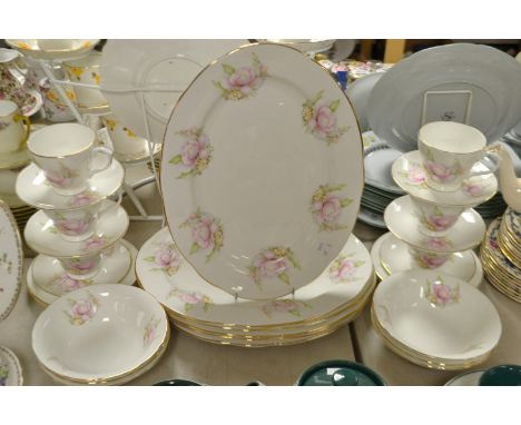 An Albany bone china tea and dinner service decorated with roses and garden flowers comprising of tea cups, saucers, side pla