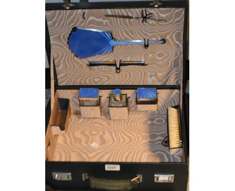 A Walker and Hall silver plated and blue guilloche enamel travelling vanity set, including hand mirror, comb, storage contain