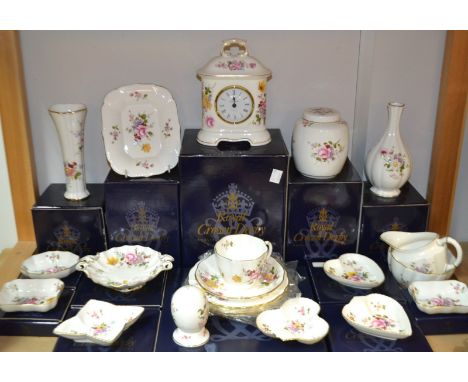 A Royal Crown Derby Posie pattern mantel clock, boxed; a ginger jar and cover, boxed; an Easter egg, trinket dishes, teacup a