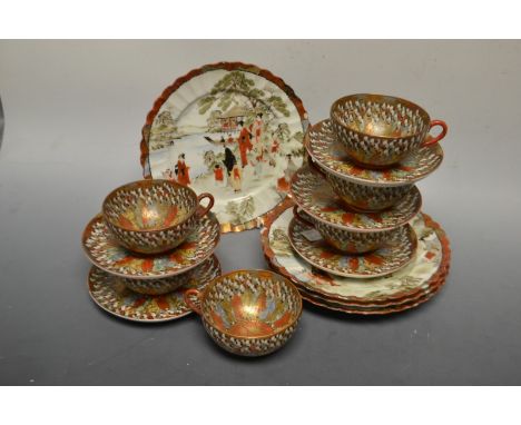A Japanese eggshell porcelain part tea service, decorated in the One Thousand Elders pattern, including six cups and five sau