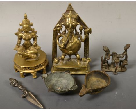 A Tibetan phurba; a tribal art figure of a man washing his hands, another brushing his teeth; etc
