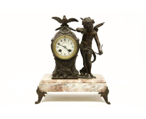 A late Continental marble and spelter mounted mantel clock, the drum movement with Cupid standing by, 28cm wide