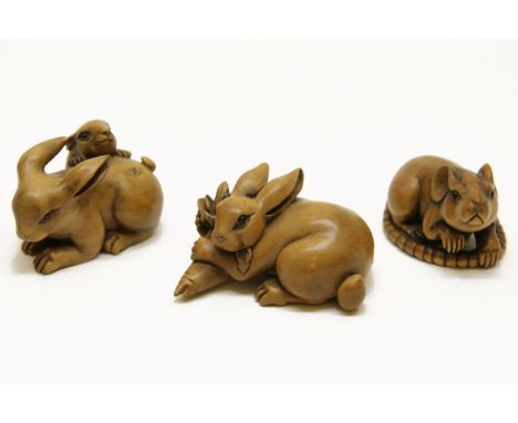 Three carved wood netsuke, a rabbit and kit, a rabbit grasping a carrot, and a rat (3)